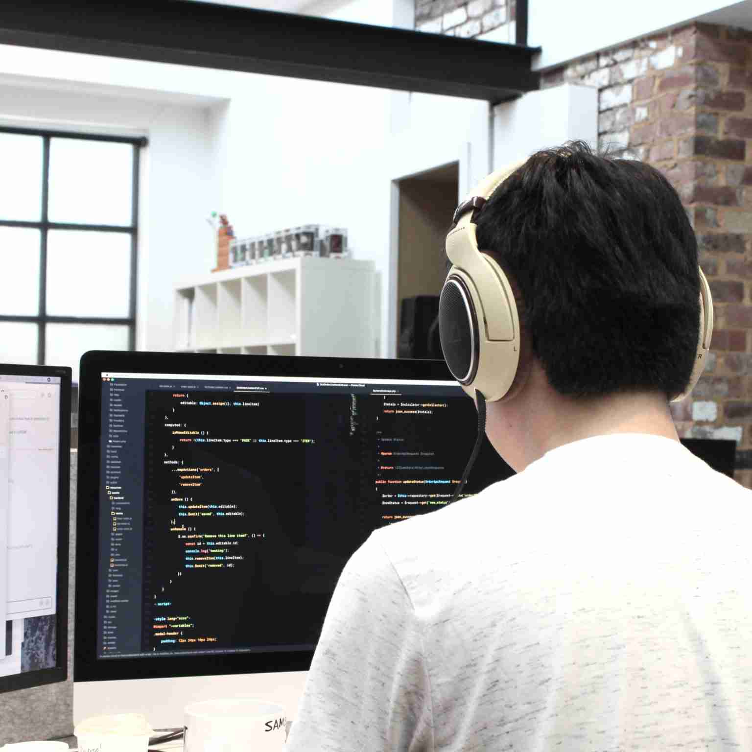 Dojo Five firmware engineer works at a computer on code