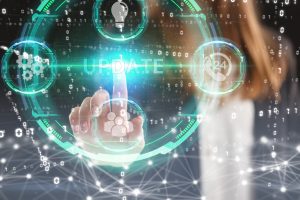 A finger moves toward the word update on a artistic depiction of technology
